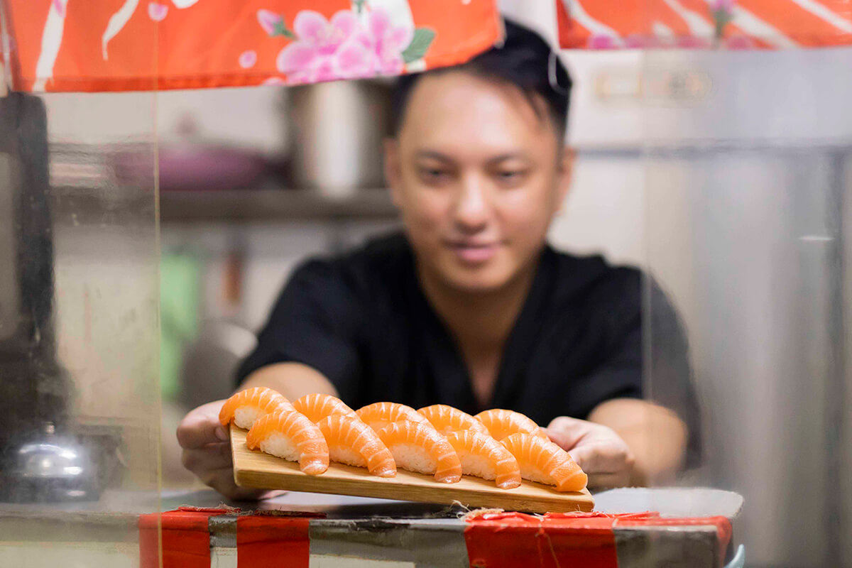 Young Sushi Master Thriving in a Fresh Market